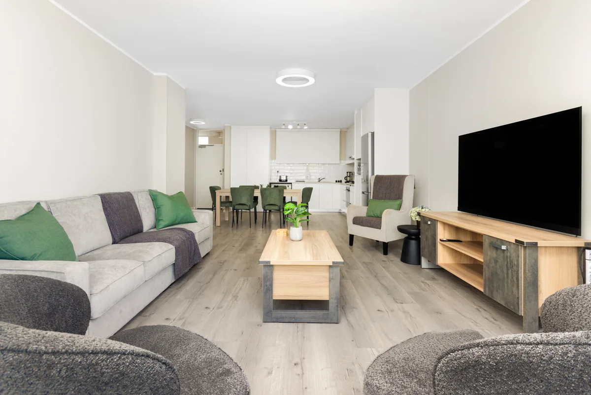 Open-plan lounge leading naturally towards the dining area and kitchen in apartment 1102