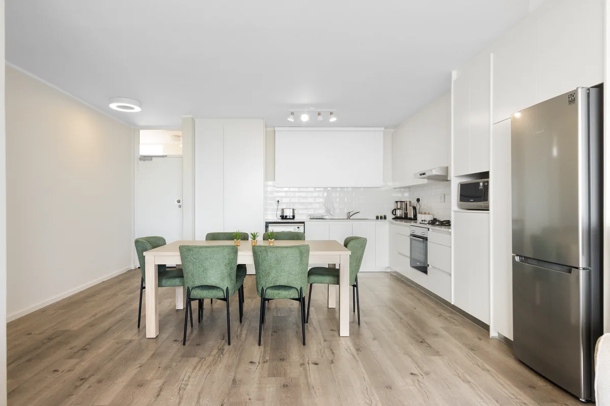 Open-plan dining area and fully equipped kitchen in apartment 1102