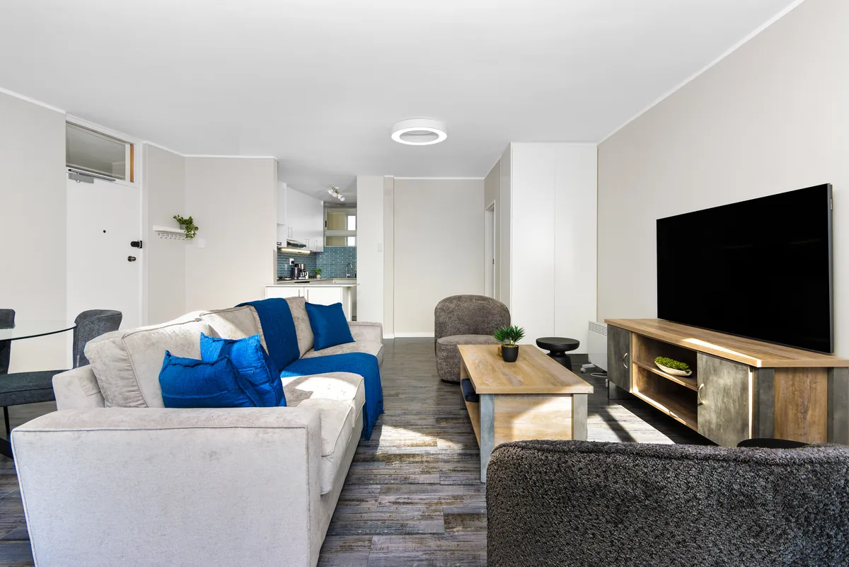 Bright living room with blue coastal accents and a smart TV