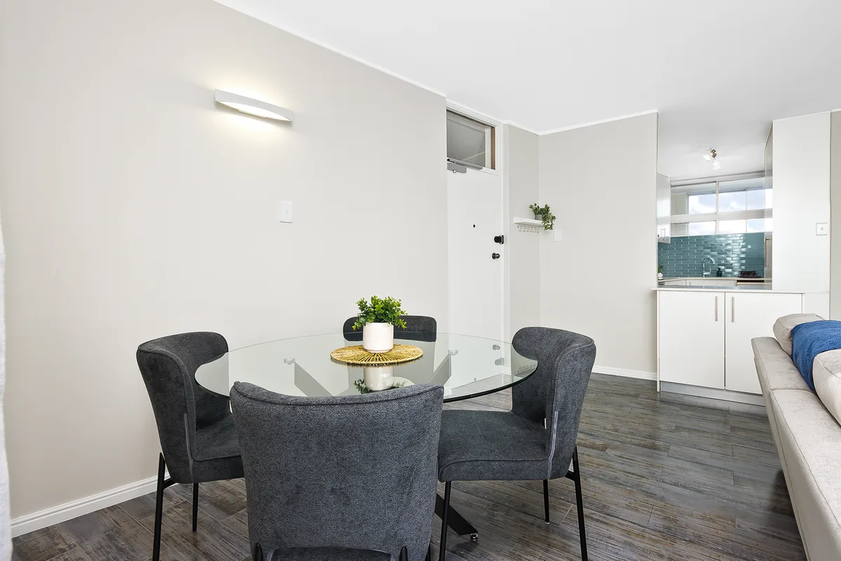 Four-seat dining table between the lounge and kitchen