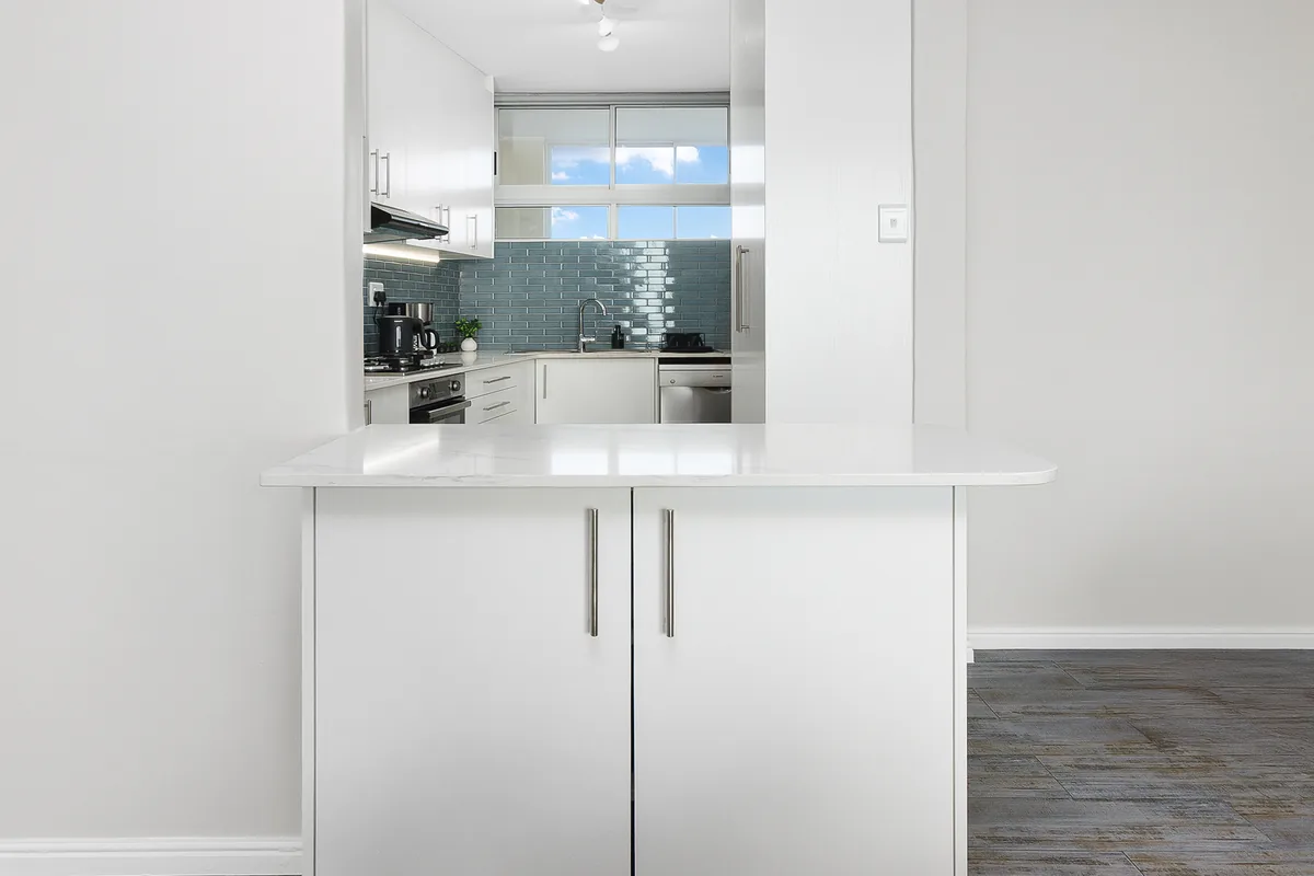 Kitchen pass-through connecting the dining area and entrance hall